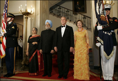 President George W. Bush, Laura Bush and India Prime Minister Dr. Manmohan Singh and Mrs. Gursharan Kaur, arrive for the official dinner in the State Dining Room at the White House Monday, July 18, 2005. White House photo by Krisanne Johnson