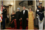 President George W. Bush, Laura Bush and India Prime Minister Dr. Manmohan Singh and Mrs. Gursharan Kaur, arrive for the official dinner in the State Dining Room at the White House Monday, July 18, 2005. White House photo by Krisanne Johnson