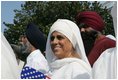 A guest attending the official arrival of India's Prime Minister Dr. Manmohan Singh, holds an American and India flag, Monday, July 18, 2005, on the South Lawn of the White House. 