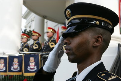 A member of the 3rd U.S. Infantry Old Guard Ceremonial Unit salutes Monday, July 18, 2005, at the arrival ceremony for India's Prime Minister Dr. Manmohan Singh, on the South Lawn of the White House. 