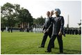 President George W. Bush walks with India's Prime Minister Dr. Manmohan Singh, Monday, July 18, 2005, on the South Lawn of the White House, during Singh's official arrival ceremony. 