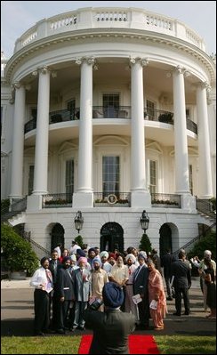 President George W. Bush reviews an honor guard with India's Prime Minister Dr. Manmohan Singh, Monday, July 18, 2005, on the South Lawn of the White House, during Singh's official arrival ceremony. 
