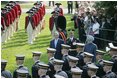 President George W. Bush reviews an honor guard with India's Prime Minister Dr. Manmohan Singh, Monday, July 18, 2005, on the South Lawn of the White House, during Singh's official arrival ceremony. 
