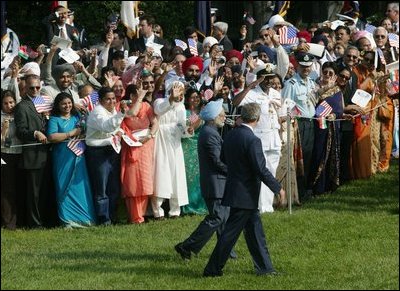 President George W. Bush and India's Prime Minister Dr. Manmohan Singh are cheered by invited guests, Monday, July 18, 2005 on the South Lawn of the White House, during the official arrival ceremony for Prime Minister Singh. 