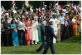 President George W. Bush and India's Prime Minister Dr. Manmohan Singh are cheered by invited guests, Monday, July 18, 2005 on the South Lawn of the White House, during the official arrival ceremony for Prime Minister Singh. 