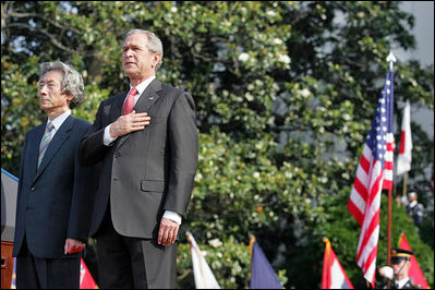 President George W. Bush and Prime Minister Junichiro Koizumi of Japan stand for the playing of the two countries' national anthems during the arrival ceremony on the South Lawn Thursday, June 29, 2006.