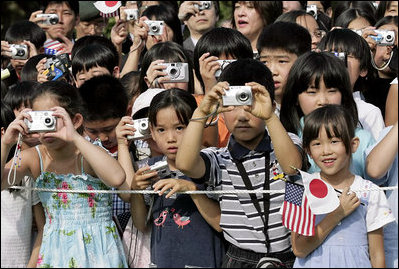 President George W. Bush and Prime Minister Junichiro Koizumi of Japan are greeted by an enthusiastic crowd of young guests during an arrival ceremony on the South Lawn Thursday, June 29, 2006.