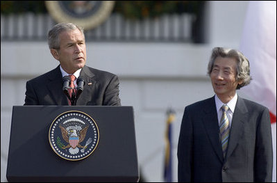 President George W. Bush delivers an address during an arrival ceremony for Prime Minister Junichiro Koizumi of Japan on the South Lawn Thursday, June 29, 2006. "Decades ago, our two fathers looked across the Pacific and saw adversaries, uncertainty and war," said President Bush. "Today their sons look across that same ocean and see friends and opportunity and peace."