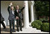 President George W. Bush and Prime Minister Junichiro Koizumi of Japan wave from the steps of the Rose Garden before meeting in the Oval Office Thursday, June 29, 2006.