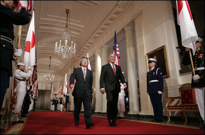 President George W. Bush and Japan’s Prime Minister Junichiro Koizumi walk through Cross Hall on their way to a joint press availability Thursday, June 29, 2006, in the East Room of the White House.