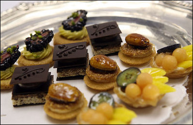 In addition to sugary rose blossom, guests at the State Dinner are treated to a variety of petit fours. From left, they are blackberry shortbread and pistachio; dark chocolate leaves and orange ganache; praline crunch and marcona almond and a tiny tarts of papaya, mango and blueberries. White House photo by Lynden Steele