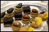 In addition to sugary rose blossom, guests at the State Dinner are treated to a variety of petit fours. From left, they are blackberry shortbread and pistachio; dark chocolate leaves and orange ganache; praline crunch and marcona almond and a tiny tarts of papaya, mango and blueberries. White House photo by Lynden Steele
