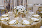 The table settings in the State Dining Room for the White House dinner Wednesday, Nov. 2, 2005, in honor of the Prince of Wales and Duchess of Cornwall. Chosen by Mrs. Laura Bush, the centerpieces are sprays of white phaeleanopsis orchids displayed in vermeil vases and compliment the Clinton China and vermeil flatware. 