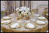 The table settings in the State Dining Room for the White House dinner Wednesday, Nov. 2, 2005, in honor of the Prince of Wales and Duchess of Cornwall.  Chosen by Mrs. Laura Bush, the centerpieces are sprays of white phaeleanopsis orchids displayed in vermeil vases and compliment the Clinton China and vermeil flatware.  