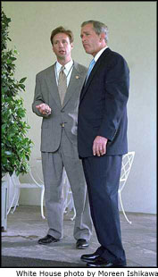 President George W. Bush talks with Dr. Richard Tubb, Brigadier General, USAF, Deputy Assistant and Physician to the President, along the West Wing Colonnade June 25, 2001.
