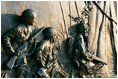 Soldiers engaged in jungle warfare are depicted in a bronze bas-relief sculpture panel on the Southern balustrade of the memorial.s ceremonial entrance wall. Twenty-four bas-relief panels were created by sculptor Ray Kaskey for the Memorial. Many panels are based on photographs from World War II.