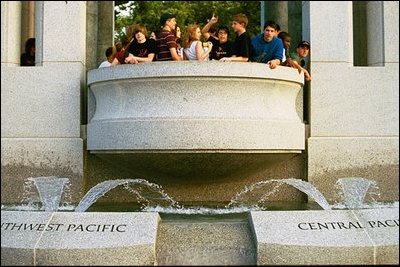 A group of young people tours the Pacific Theater Memorial Pavilion located on the southern side of the memorial. 