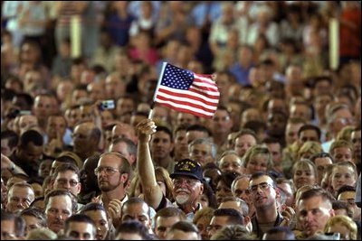 A veteran waves an American flag during President Bush's address to members of the Florida National Guard, veterans and retired members of the military at MacDill Air Force Base in Tampa, Fla., March 26, 2003. "I want to thank you all for your service, for setting such a clear example for future generations of those who wear our uniform. I think you'll agree that our military is not letting you down when it comes to upholding the great tradition of peace through strength.. said the President"